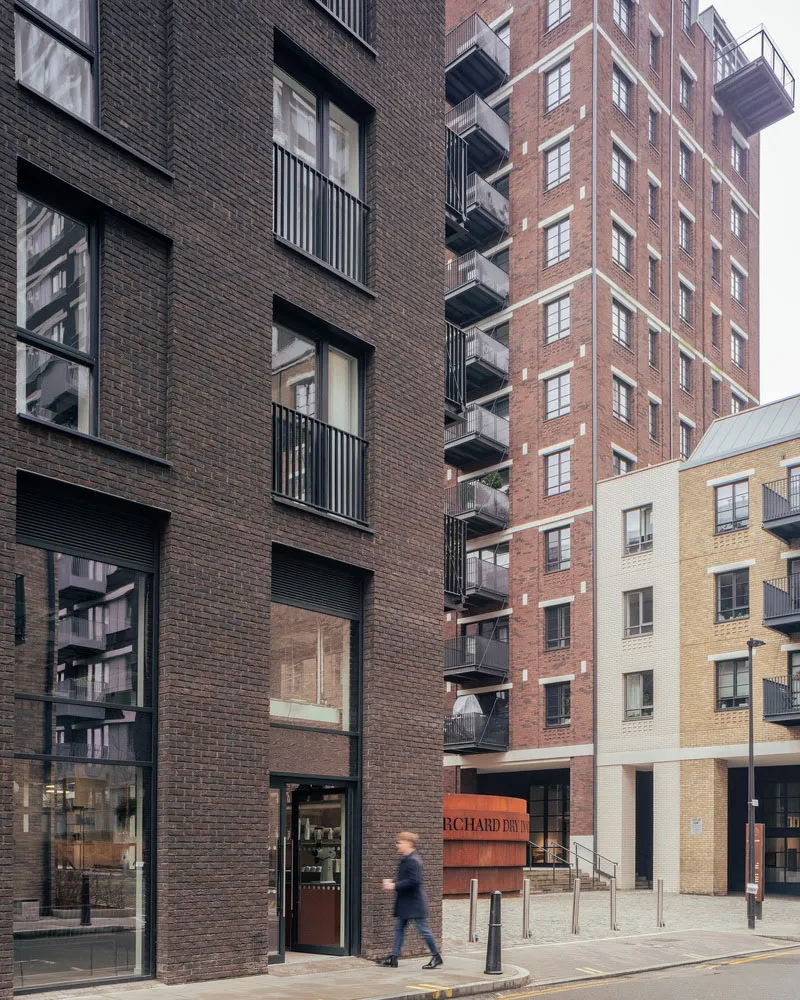 Modern brick buildings with balconies in a street view.