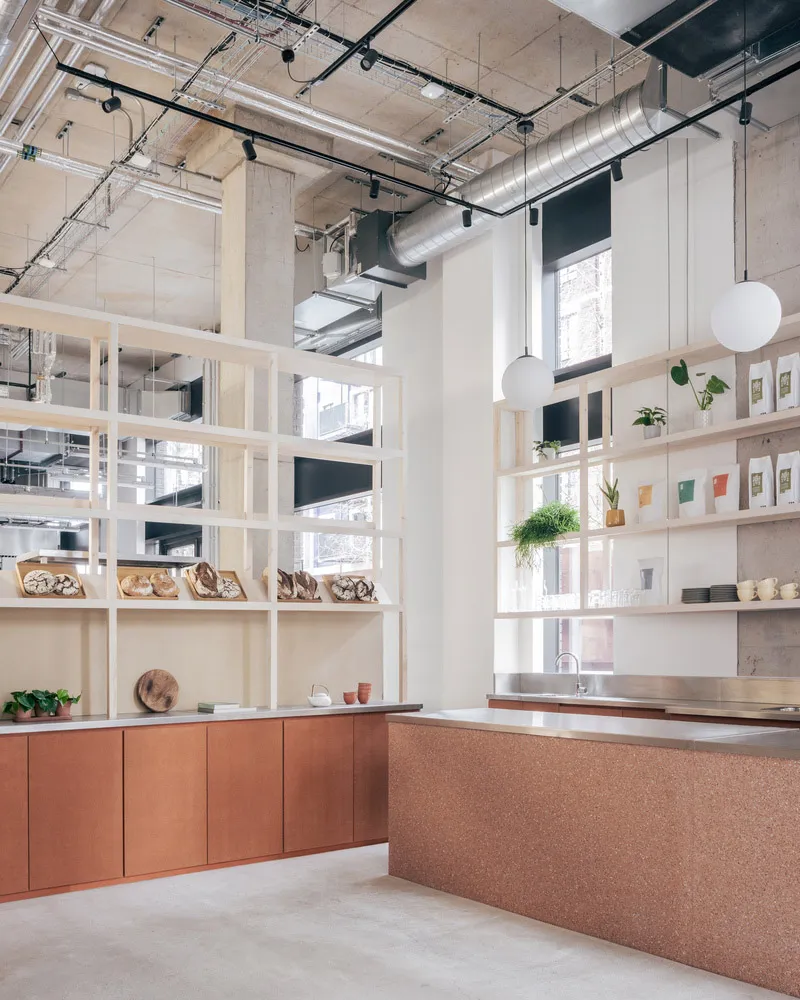Modern coffee shop interior featuring concrete, cork, and wood finishes.