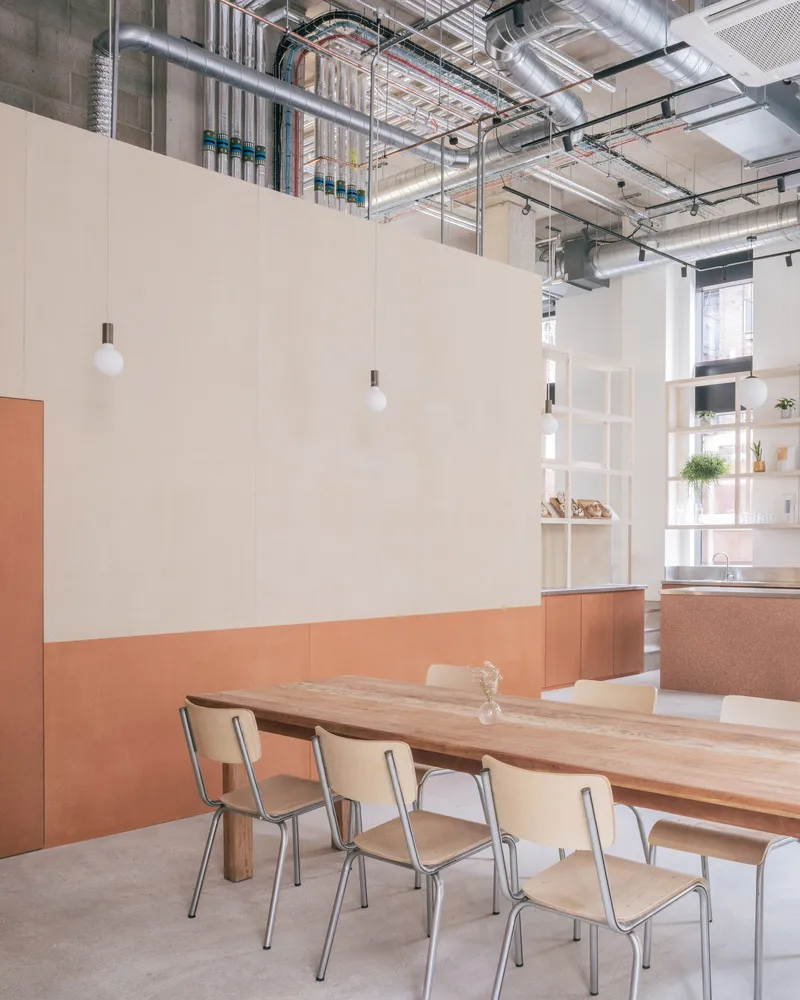 A minimalist industrial office space with wood and concrete elements.