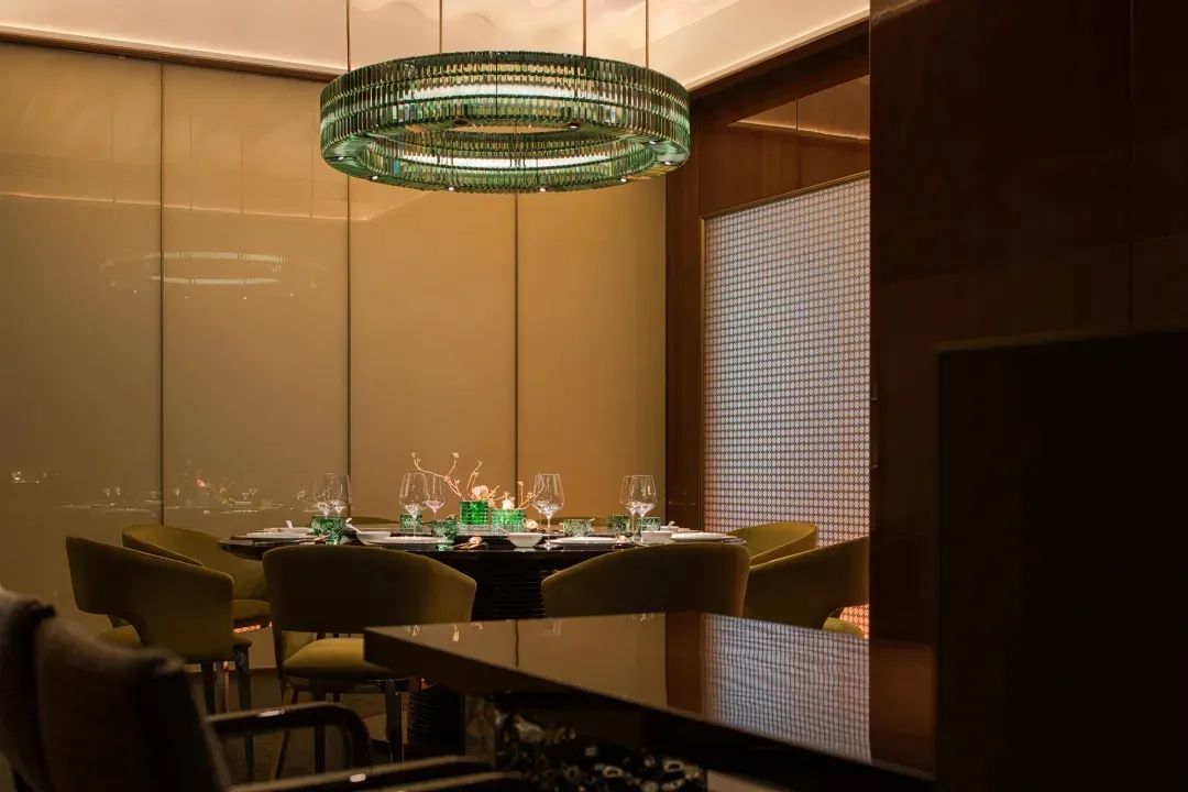 A modern restaurant interior with a glass ceiling and elegant decor.