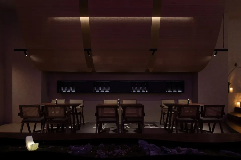 A modern bar interior featuring wood, glass, and metal materials.