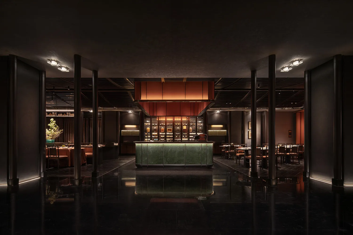 Interior of a minimalist restaurant with a marble bar, wooden tables, and metal chairs.