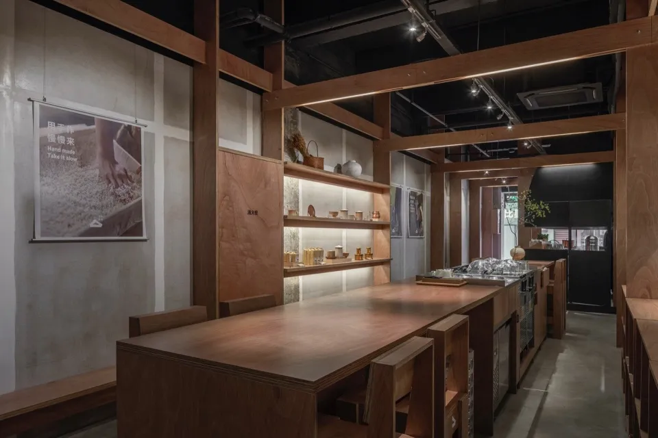A contemporary coffee shop interior featuring wooden furniture and shelves.