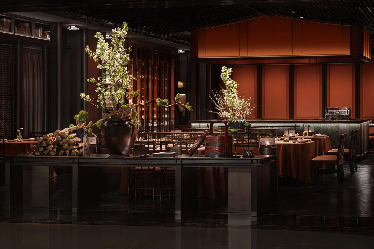 A modern restaurant bar features wooden furniture and dark metal fixtures.