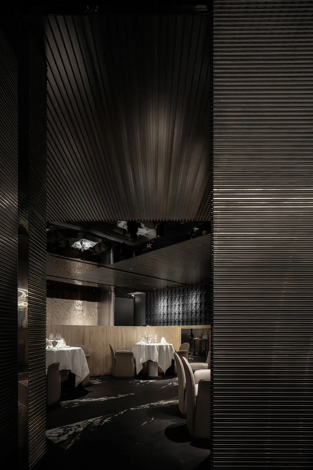 Modern restaurant interior featuring a dark, metallic design.