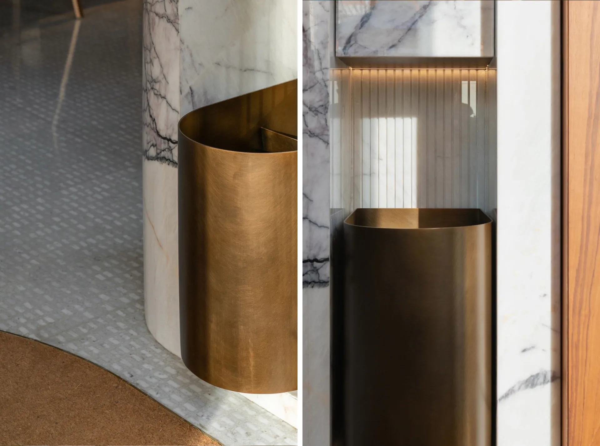 A metallic trash bin made of bronze standing next to a marble column in an interior setting.