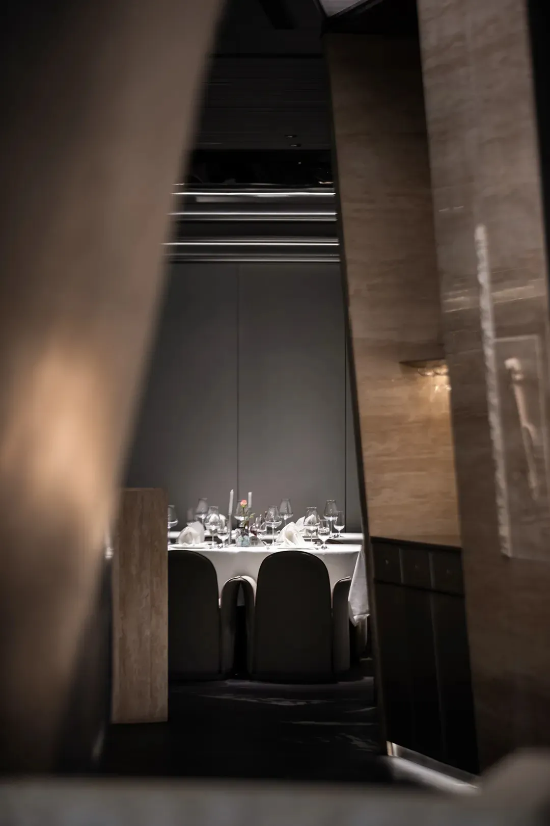 Modern restaurant interior with glass accents and contemporary furniture.
