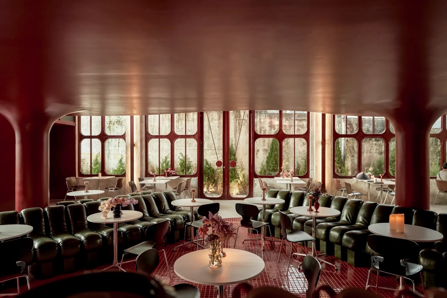 An industrial-themed restaurant interior with metal seating and tables.