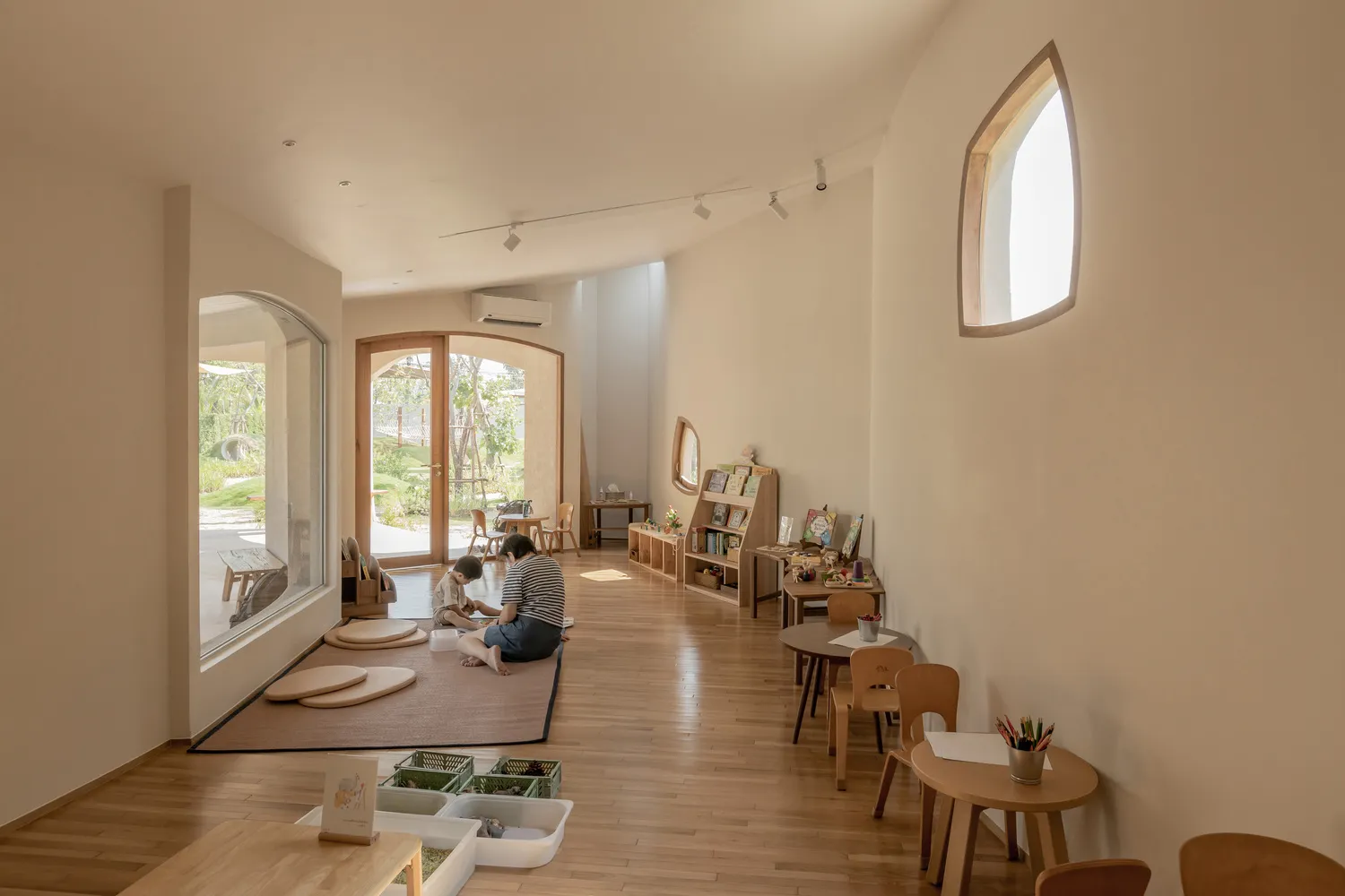 Interior view of a modern child care center with wooden and cloth surfaces