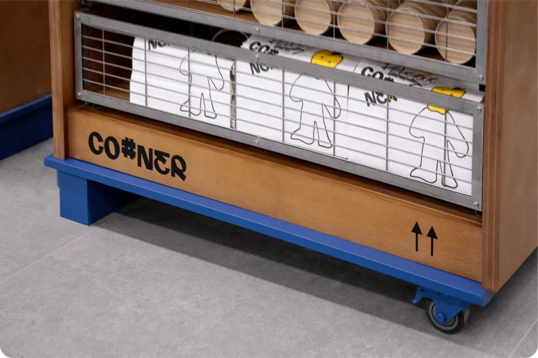 Minimalist wood cabinet with blue accents, featuring 'CO#NER' branding and storage compartments.