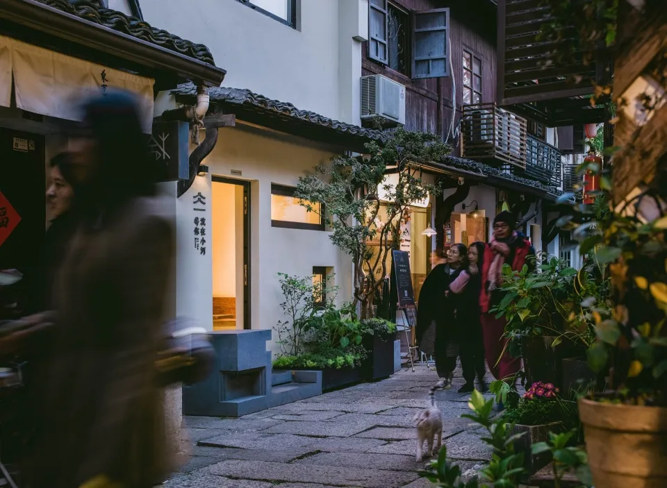 Traditional street scene with historical buildings constructed from stone, wood, and concrete