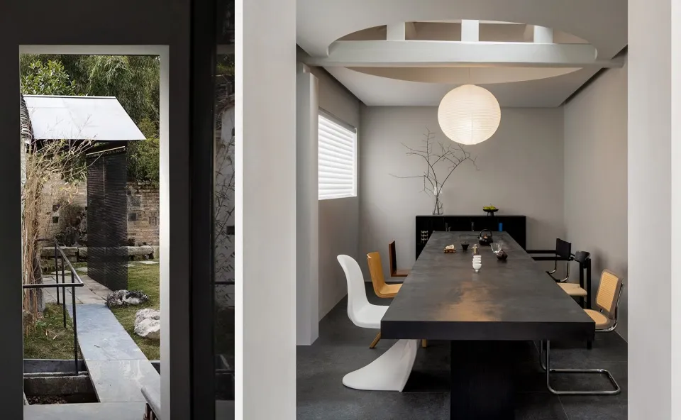 A minimalist dining room with a large concrete table and metal chairs.