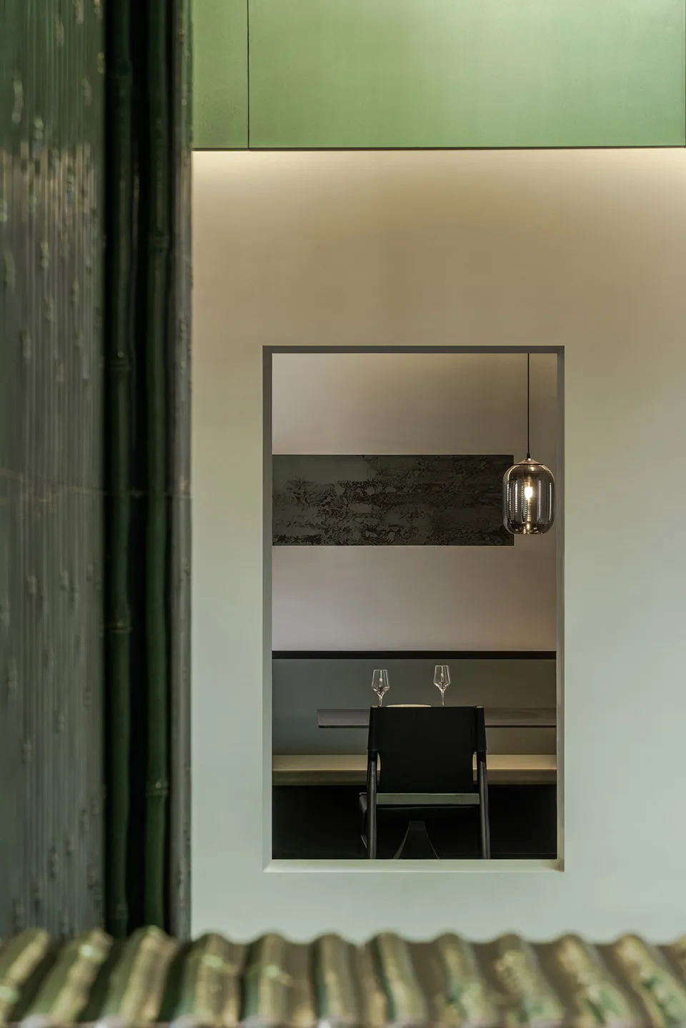 Restaurant interior featuring green structural materials and modern design elements.