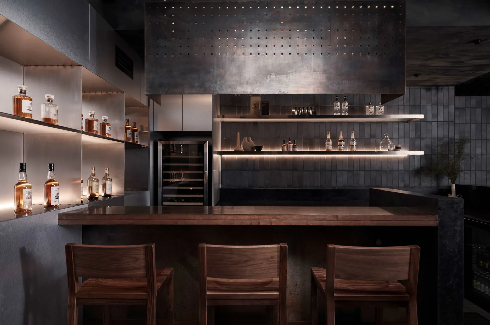 A photograph of an industrial-style bar featuring metallic and wooden elements.