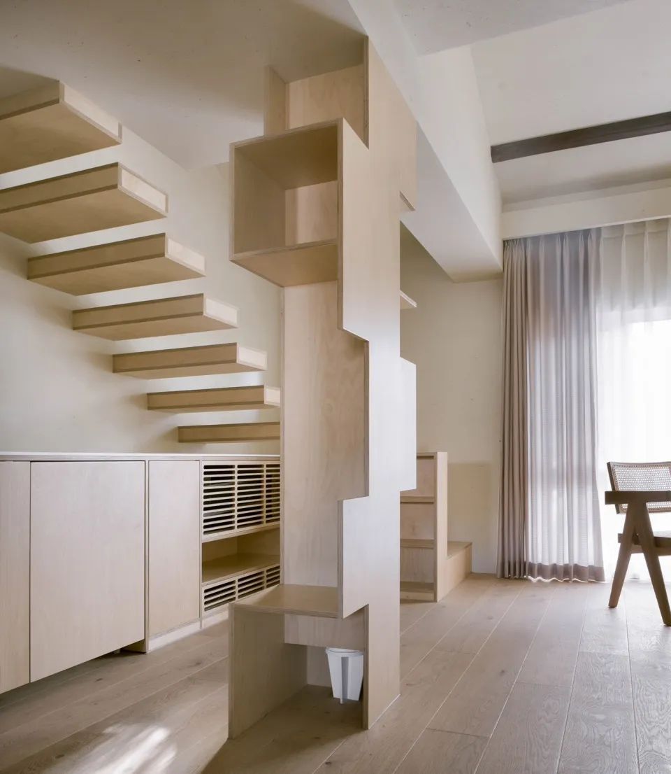 Modern interior design featuring a wooden staircase with built-in storage.