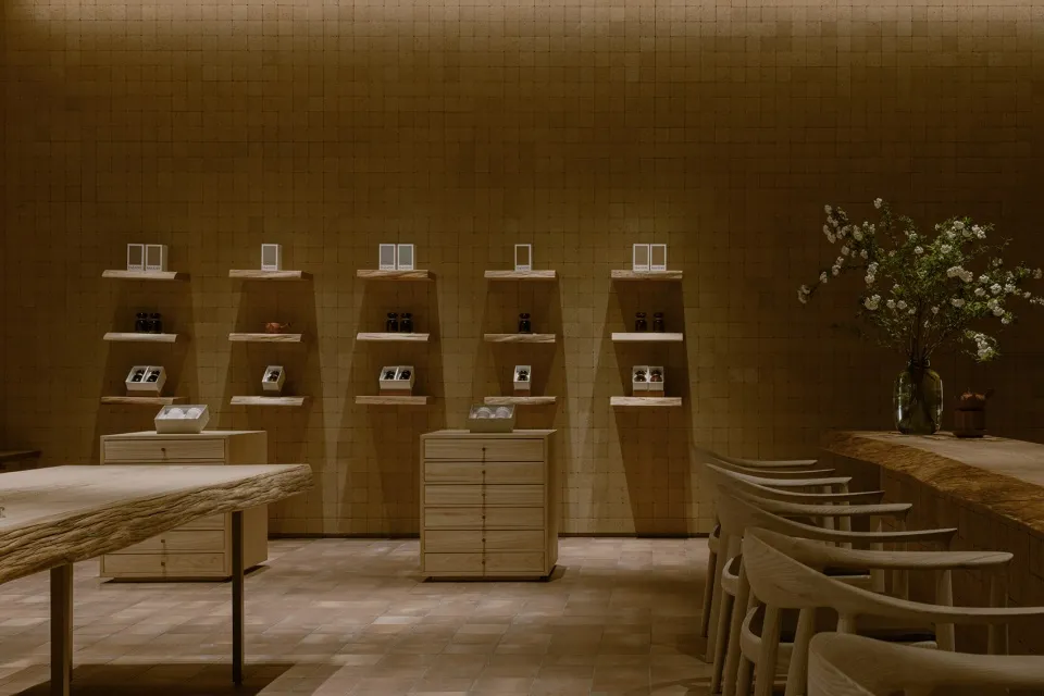 A minimalist retail storefront featuring wooden elements and shelves.