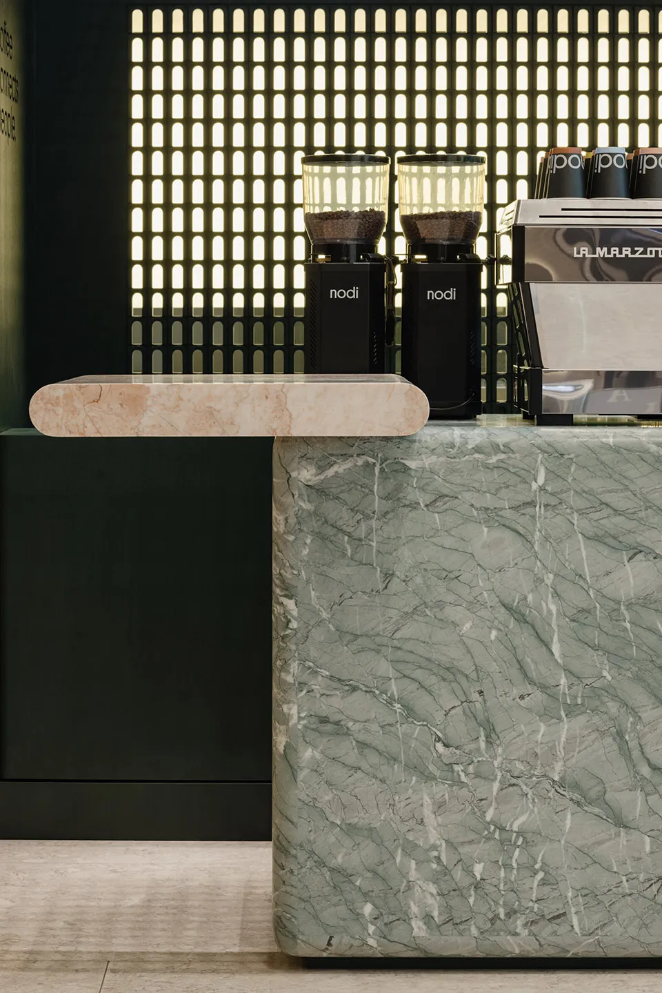 A sleek, modern coffee shop counter made of marble.