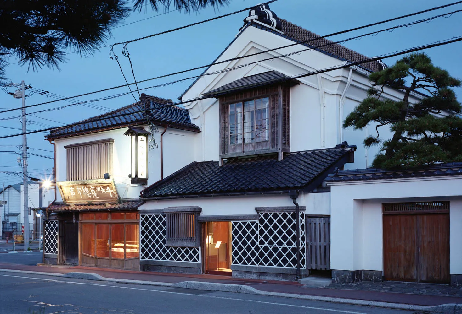 Traditional Japanese residential building constructed with concrete, wood, and metal.