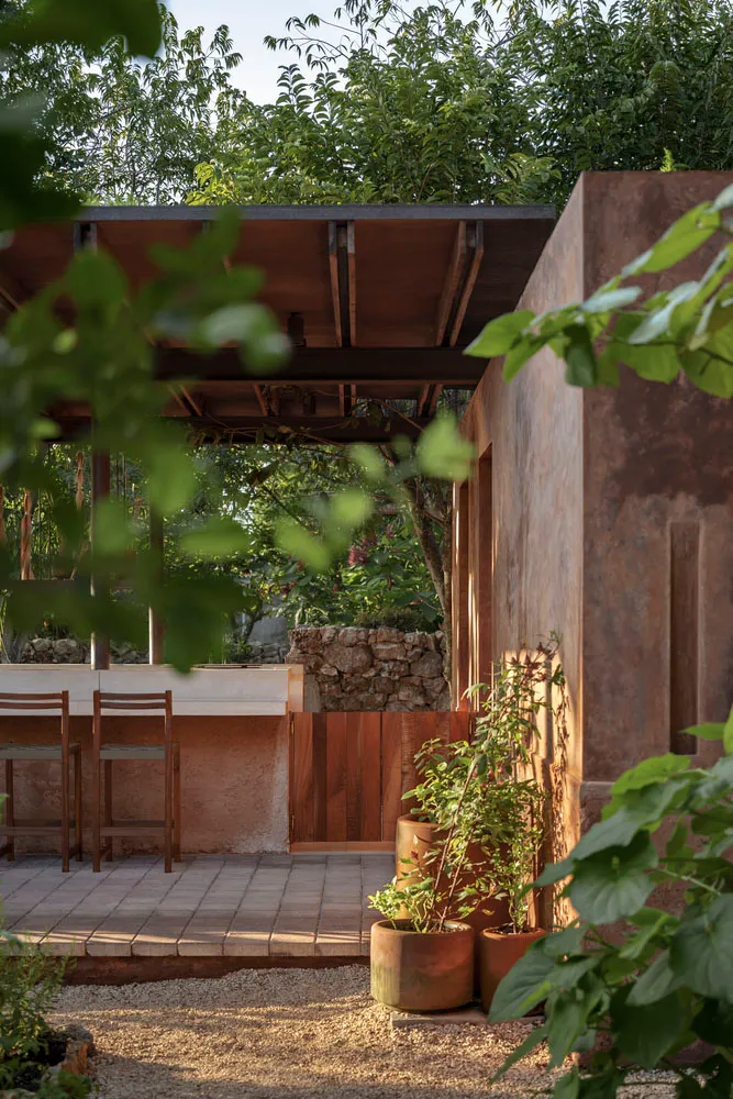 A minimalist residential patio featuring concrete and wooden elements.