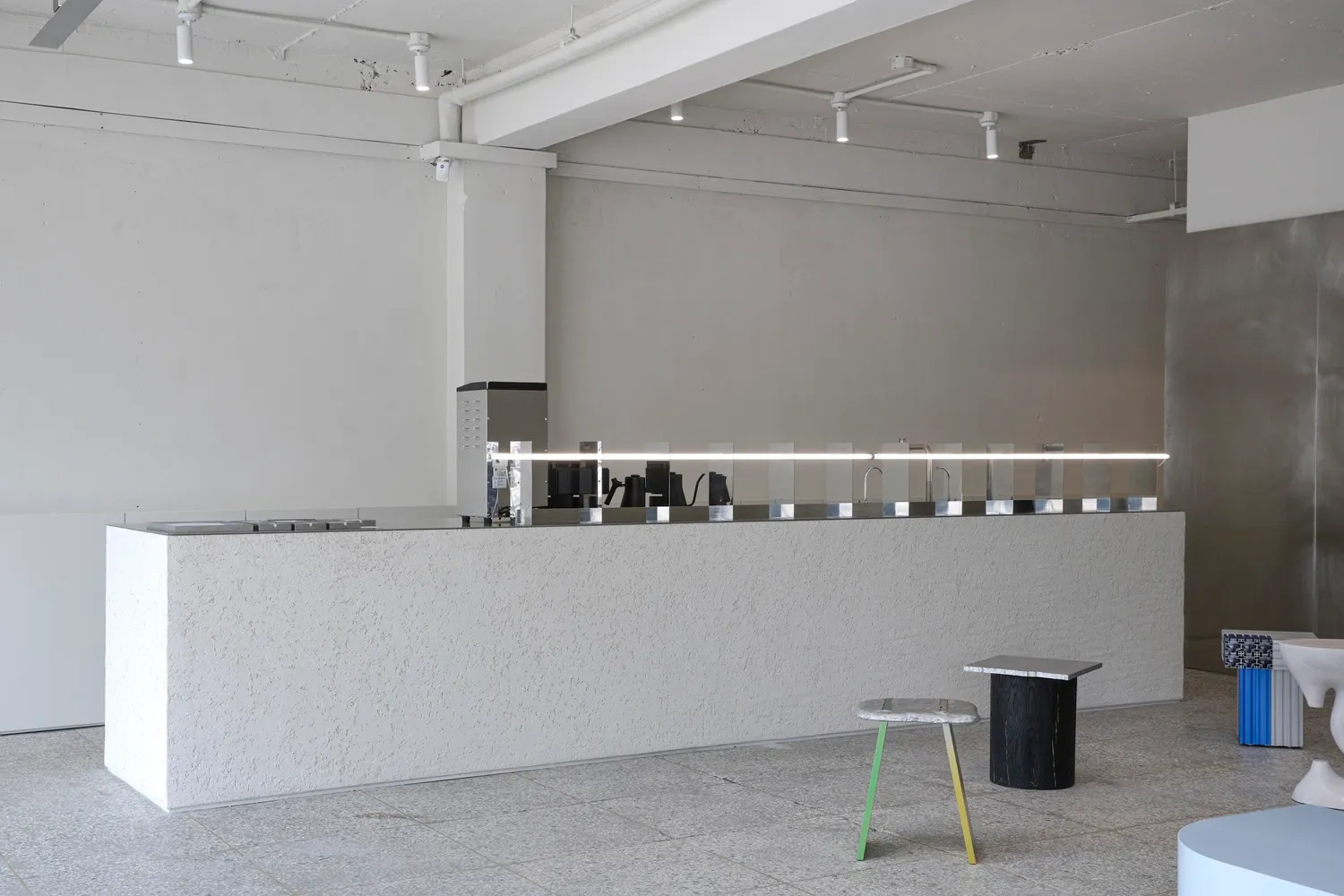 Concrete coffee shop counter with sleek design and minimalist aesthetics.
