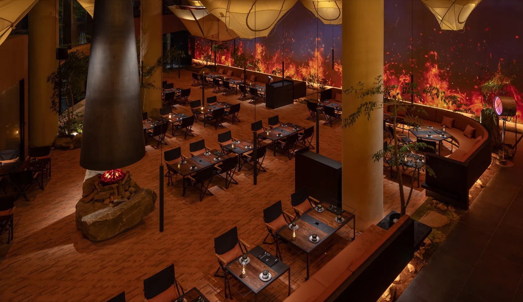 Modern dining hall with wooden floors, metal furniture, and glass elements.
