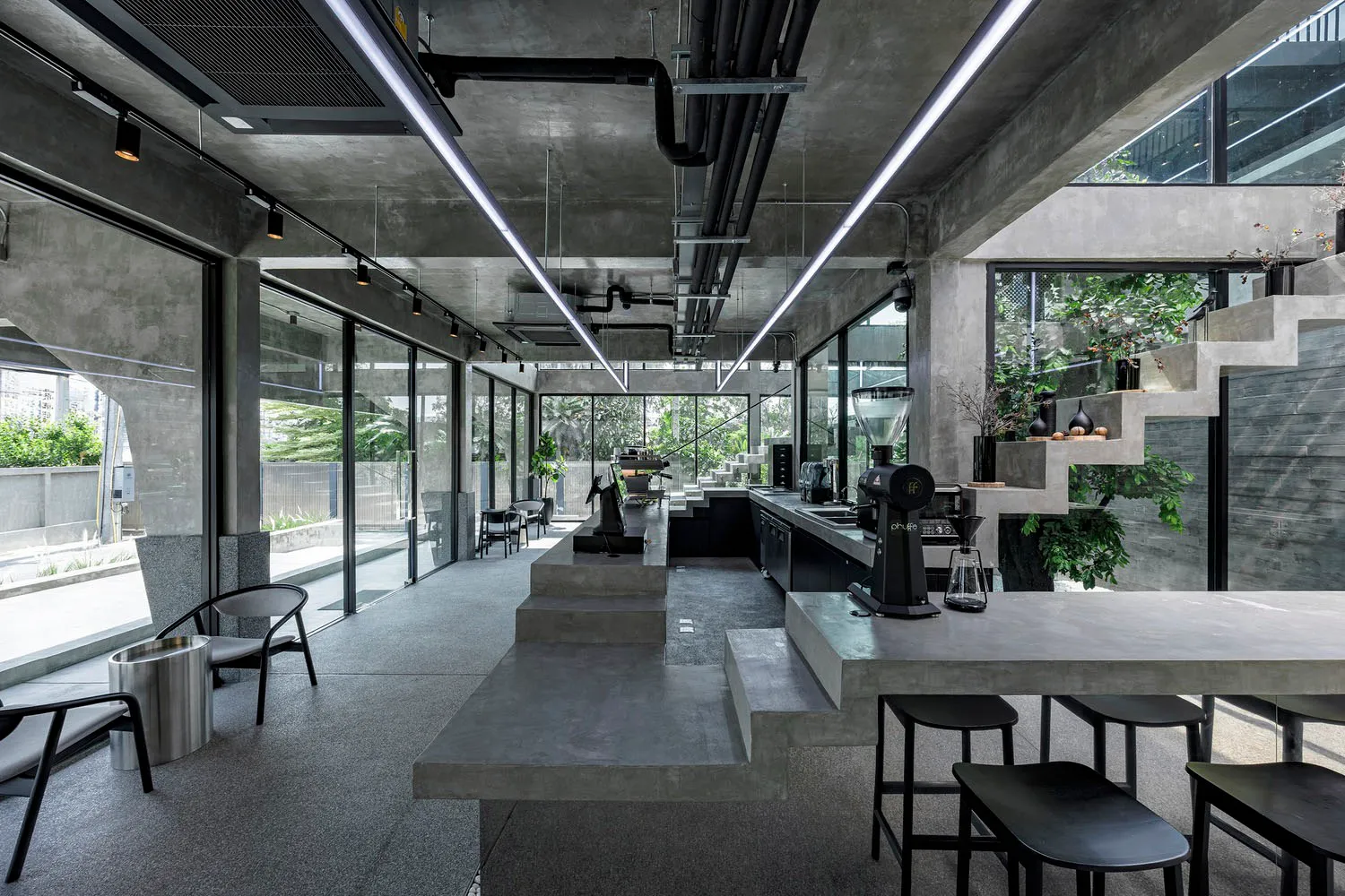 Concrete coffee shop interior with industrial design elements.