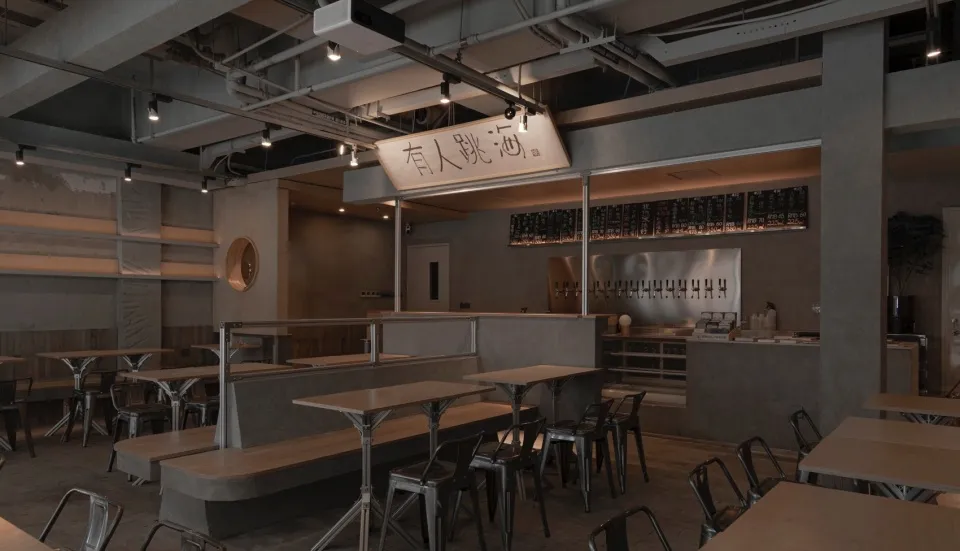 Modern, industrial-style restaurant interior with concrete walls and seating areas.
