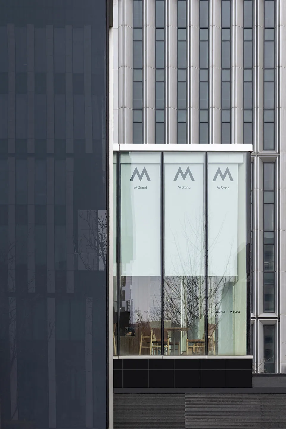 Glass, metal, and concrete facade of a modern office building.
