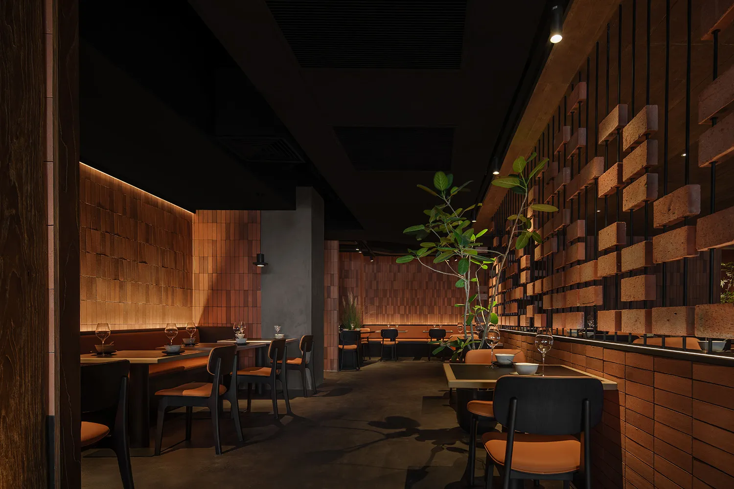 Modern restaurant interior with brick walls, wooden seating, and a minimalist design