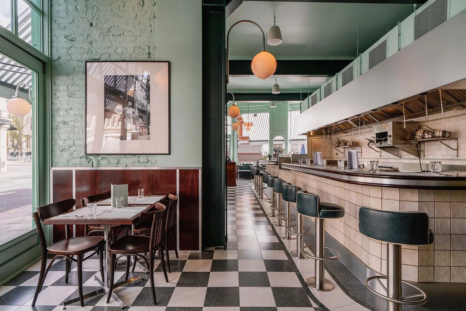 Modern cafe interior with a tiled counter featuring black and white tiles.