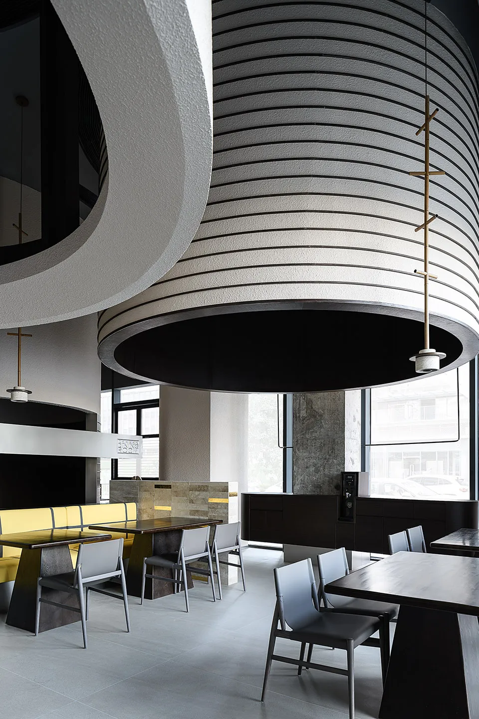 A modern cafe interior with concrete walls and wooden furniture.