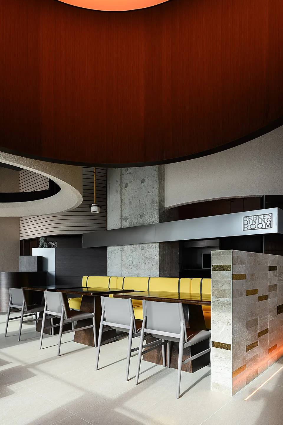 Modern restaurant interior with concrete, wood, and metal materials