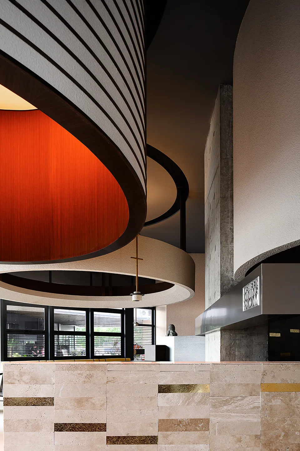 Modern restaurant interior featuring concrete and marble materials.