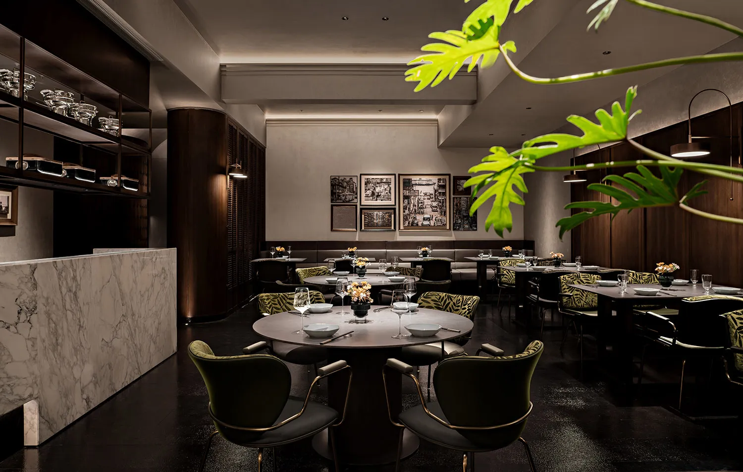 A modern indoor restaurant with marble, wooden, and glass elements.
