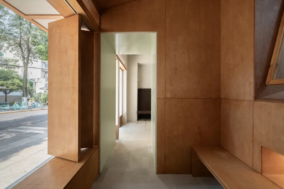 Entrance hall with wooden walls and floor.