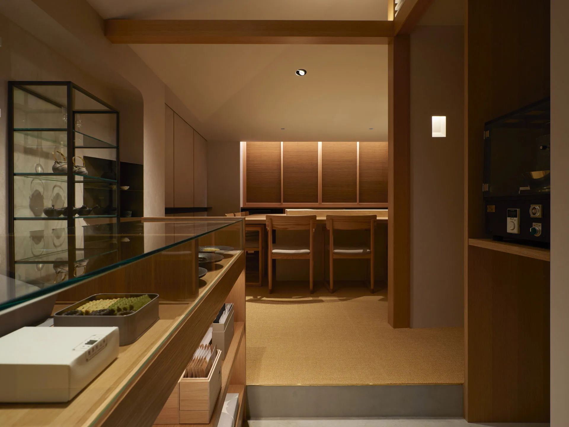 A modern restaurant interior with wooden furniture and minimalist design.