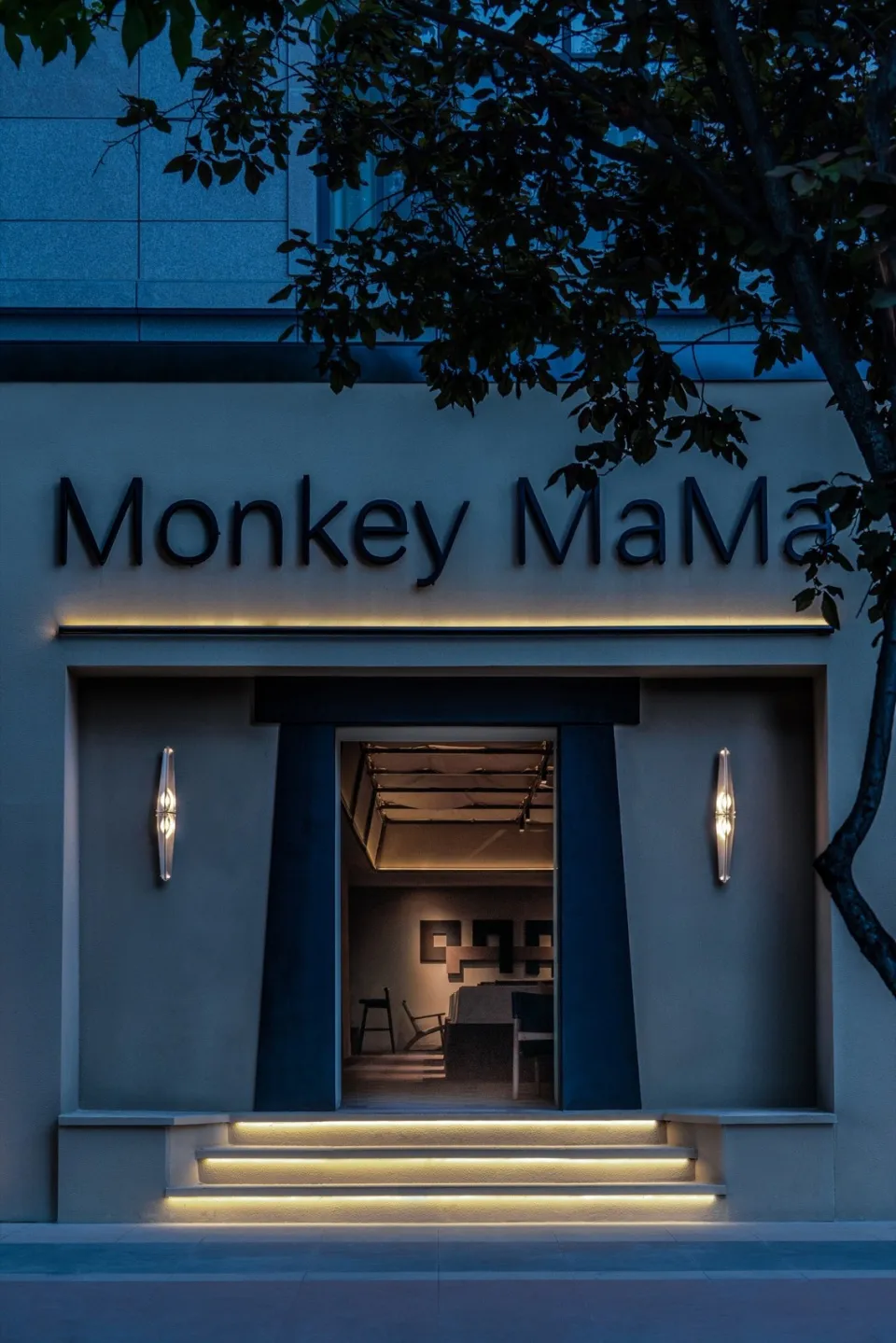 Modern retail storefront featuring concrete materials at dusk.