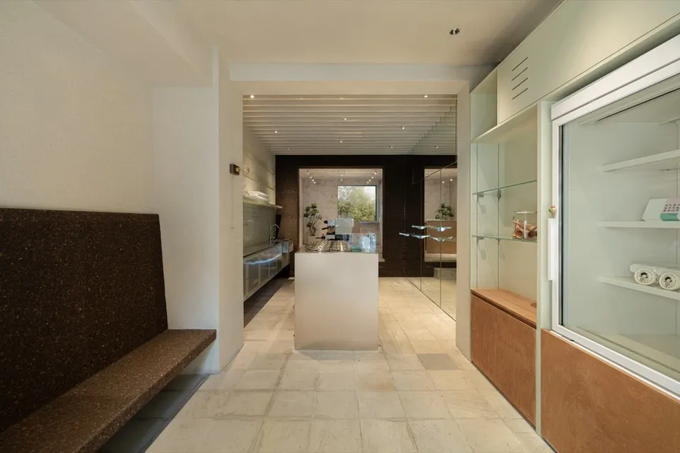 Modern storefront with glass storefront and interior counter, featuring sleek design elements.