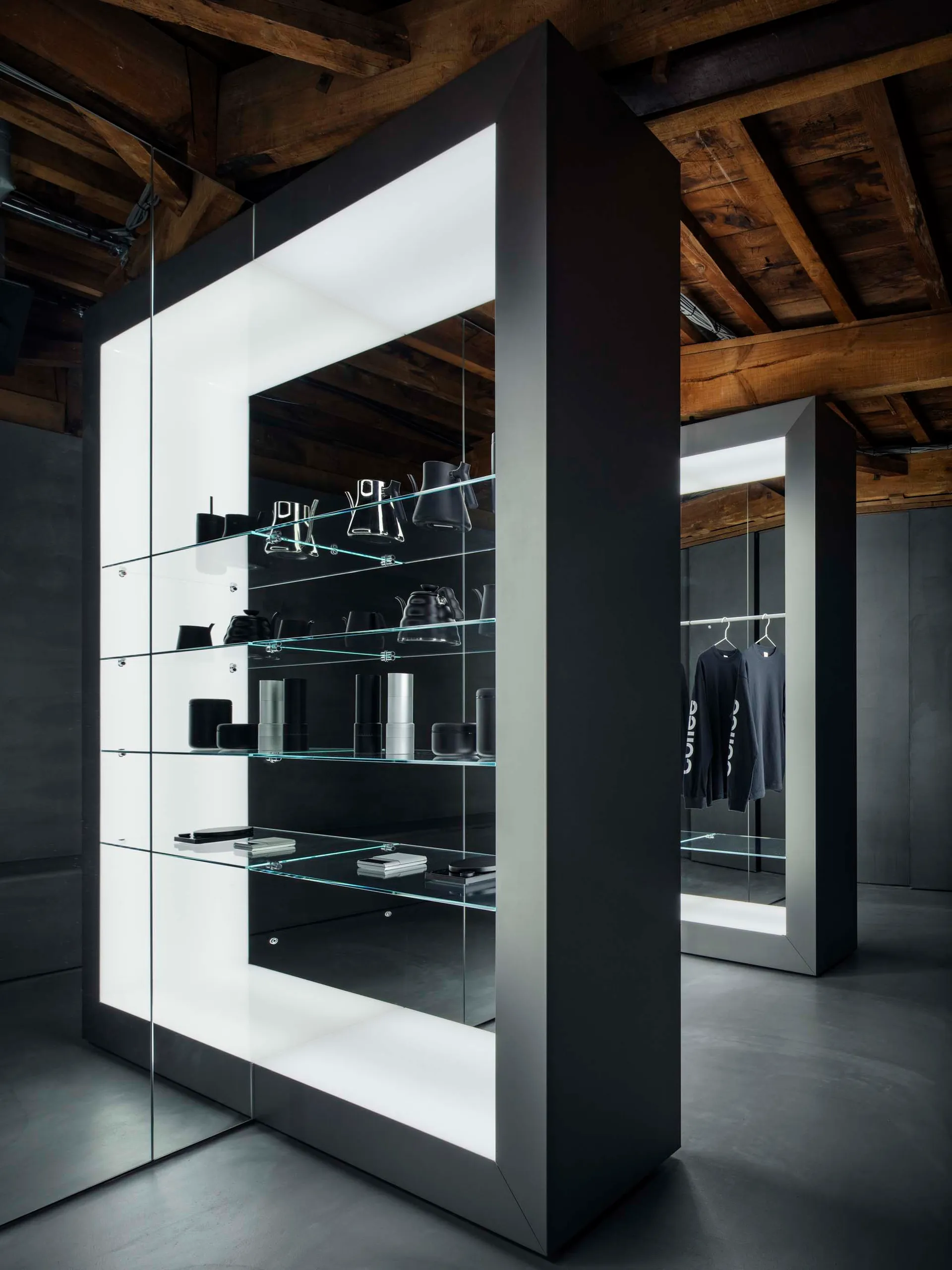 Modern retail store interior featuring glass shelves with minimalist products.