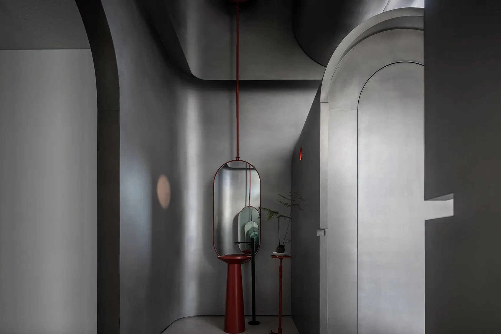 Minimalist industrial interior with metallic finishes and geometric shapes.