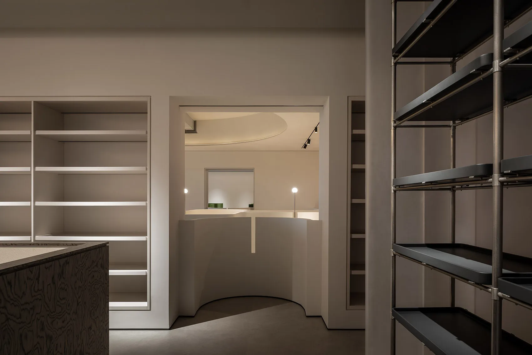 Minimalist retail store with metal and glass elements.