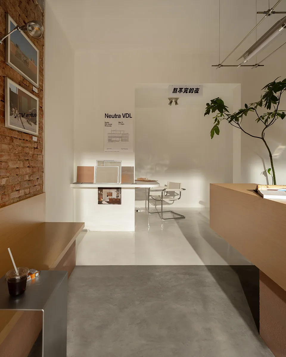 A minimalist, concrete-floored presentation hall