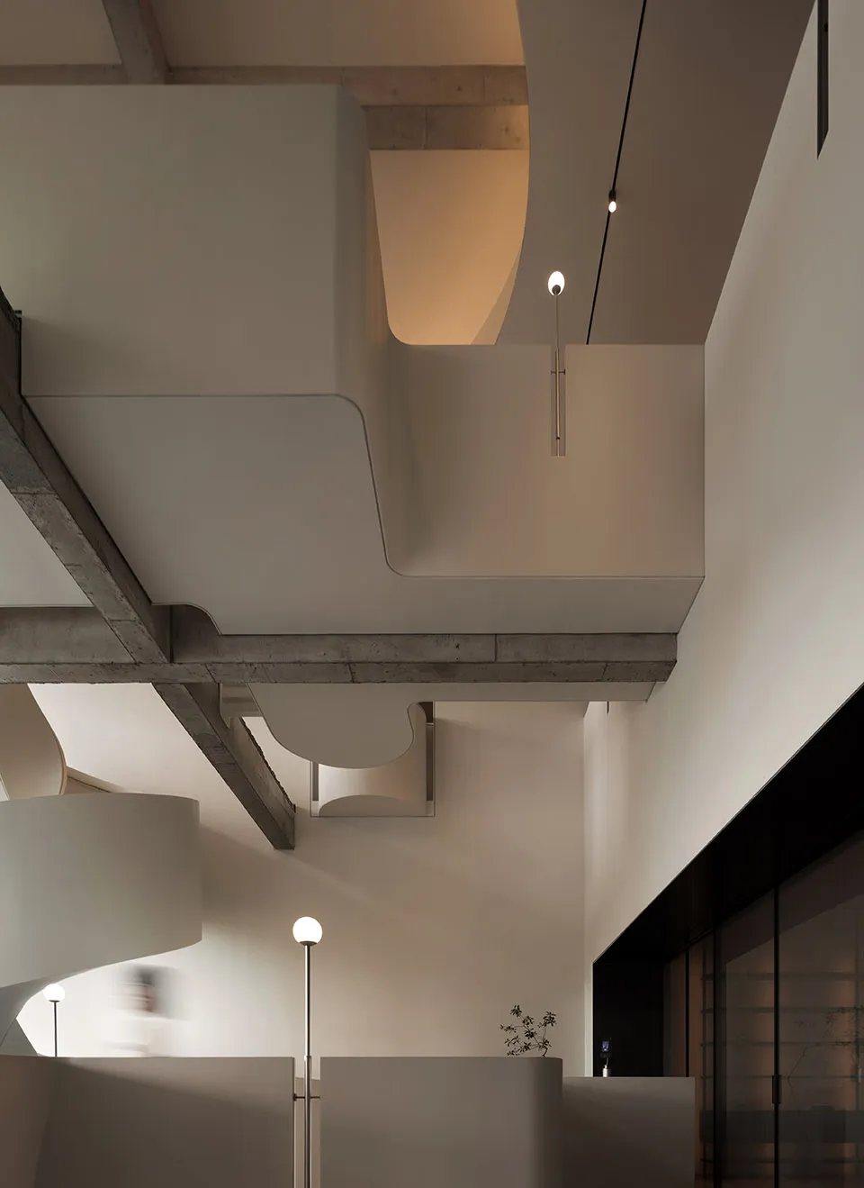 A modern office space featuring concrete architecture and ambient lighting.