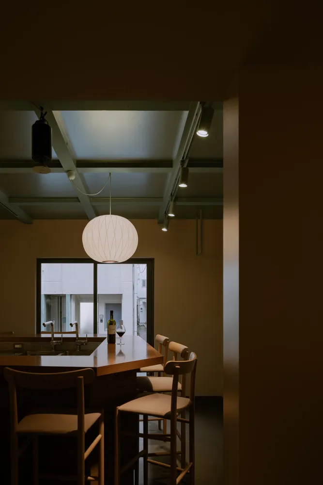 Modern kitchen bar area with pendant lighting and stools