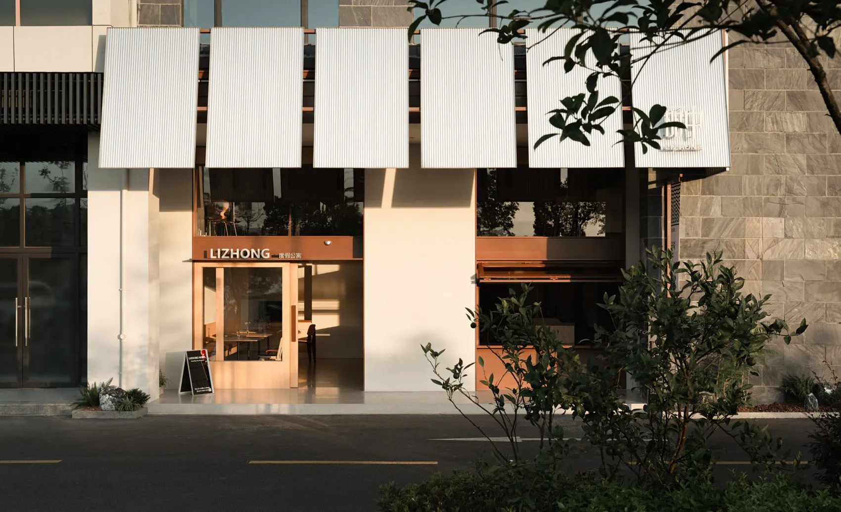 Modern commercial interior with concrete walls and glass windows.