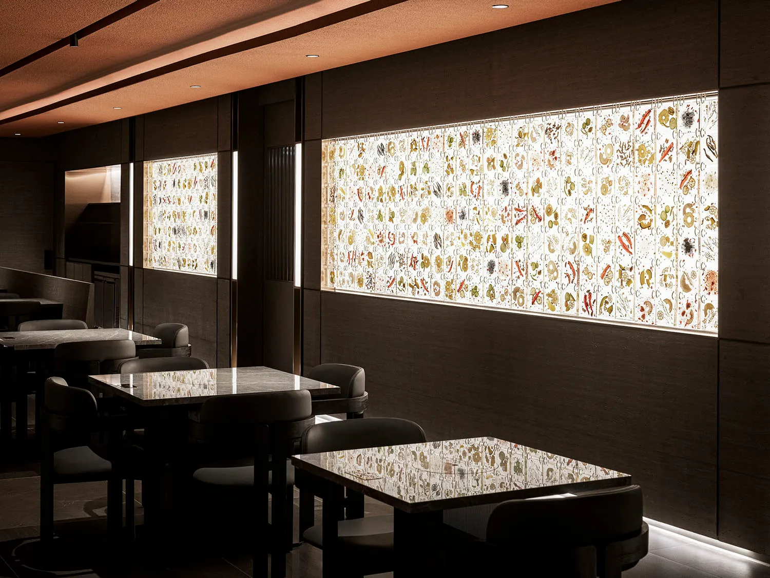 Modern restaurant interior with glass art decor including natural light, tables, chairs, and wall art.