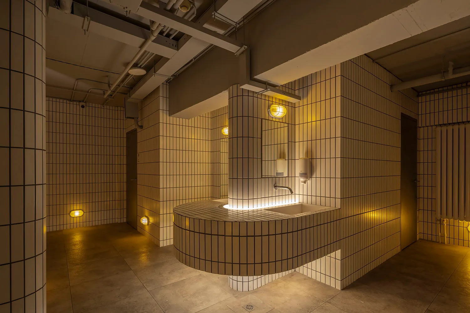 Industrial-style bathroom with tiled walls and ceiling.