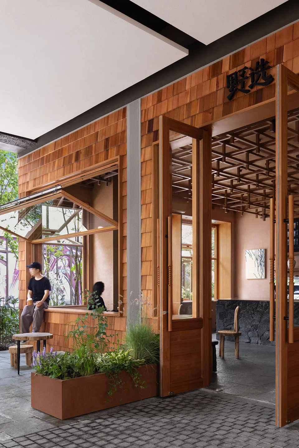 A modern coffee shop with wooden interiors and green plants