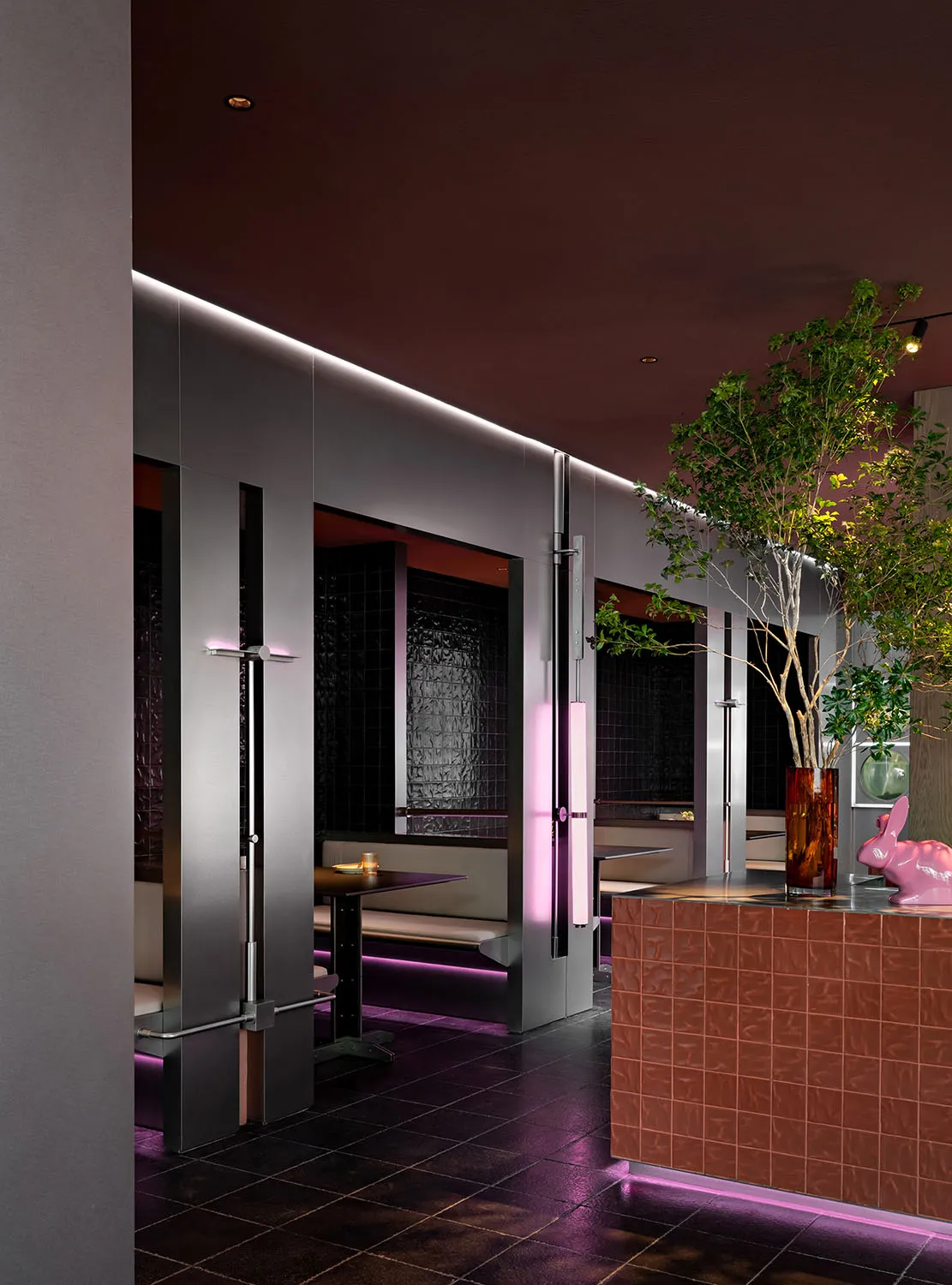 Modern, metallic, and wooden restaurant interior with glass elements.