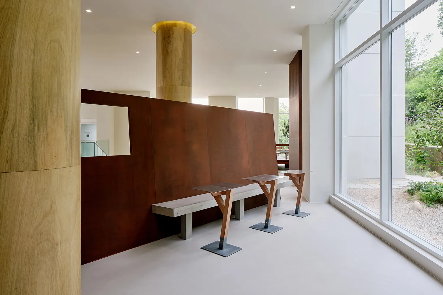 Modern industrial office lounge with concrete, metal, and wood materials.